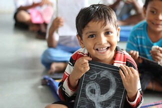 happy boy holding calkboard