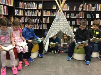 young kids reading books in a library